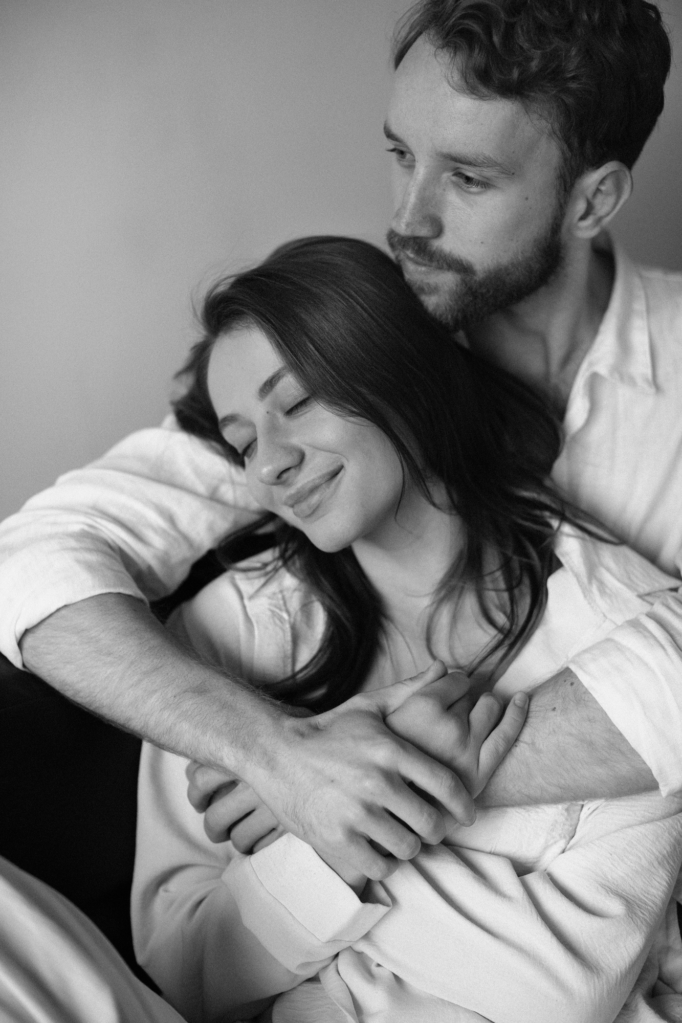 Premium open-minded couple embracing in a private dating moment